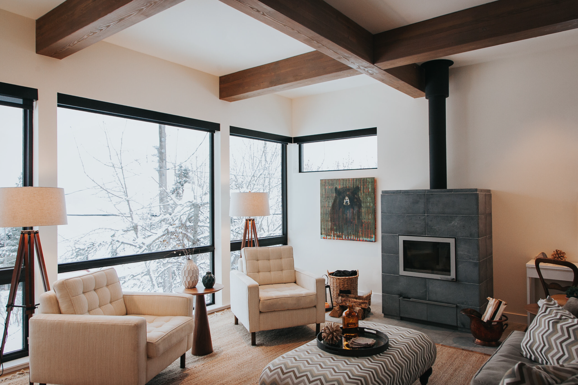 A rustic living room designed with large brown beams.